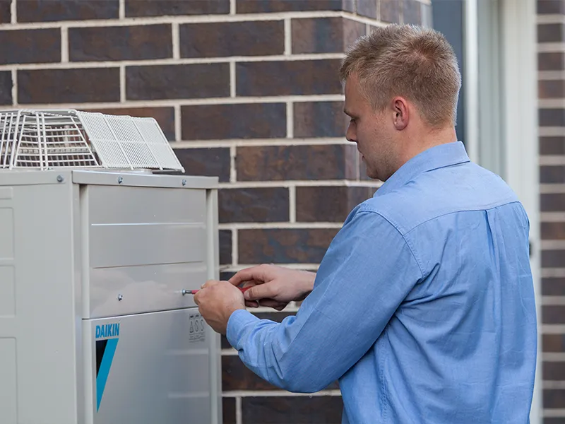 Local HVAC experts servicing an air conditioning unit