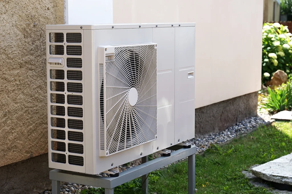 Outdoor mini split heat pump system installed beside a home — helps illustrate what size mini split you need.