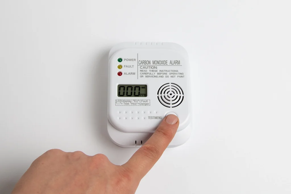 Person testing a carbon monoxide alarm that has started beeping