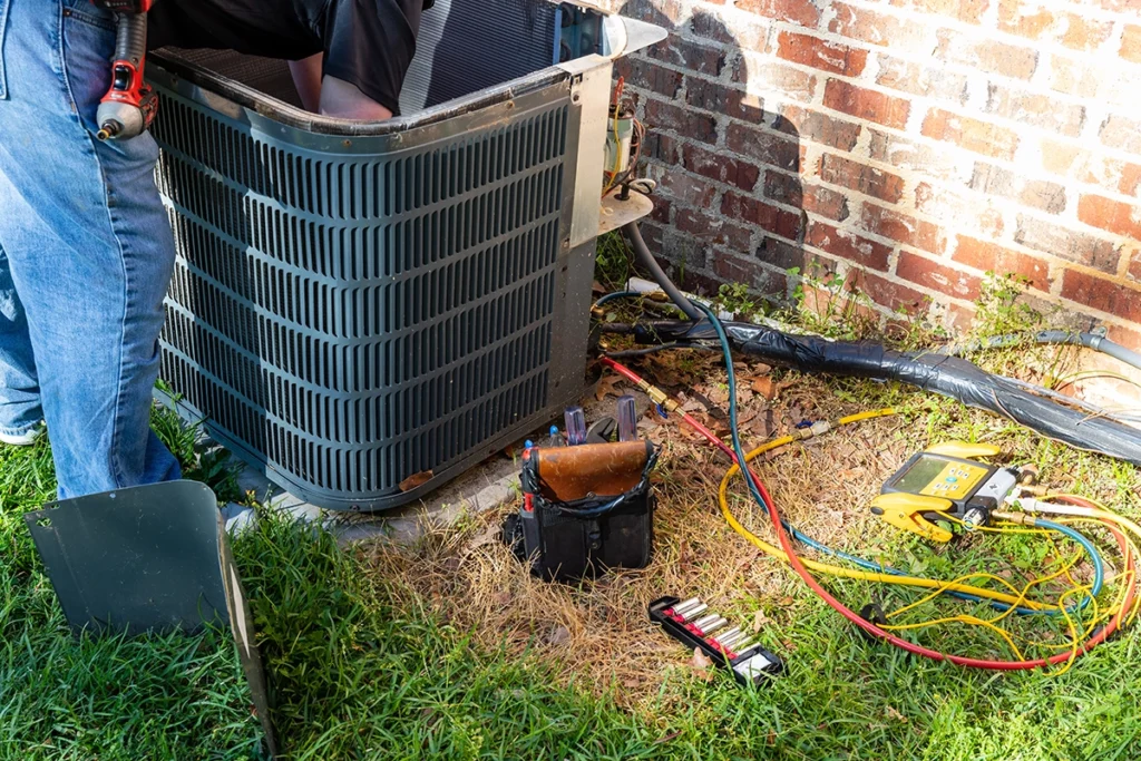 HVAC technician diagnosing an AC not turning on problem at an outdoor condenser unit