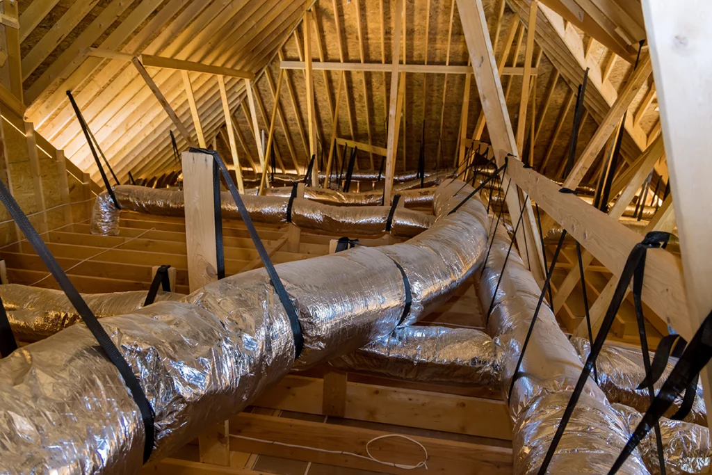 Insulated HVAC ductwork installed in an attic for residential heating and air conditioning distribution