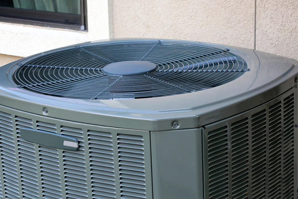 Fan in AC unit on an outdoor condenser for a residential cooling system.