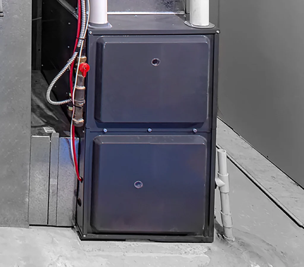 Furnace blower motor capacitor failing in Big Sandy, shown by a gas furnace and ductwork in a home utility area