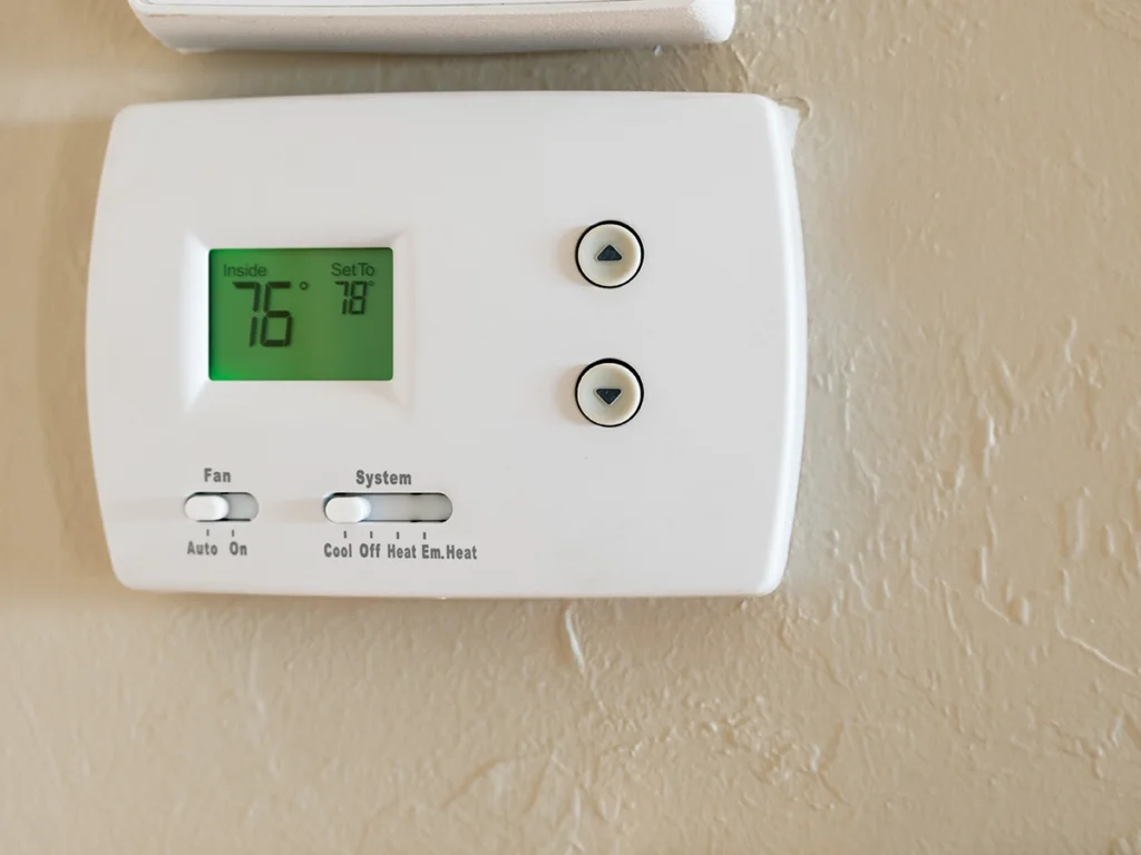 Furnace thermostat not responding to temperature changes in bullard: close-up of a wall-mounted digital thermostat